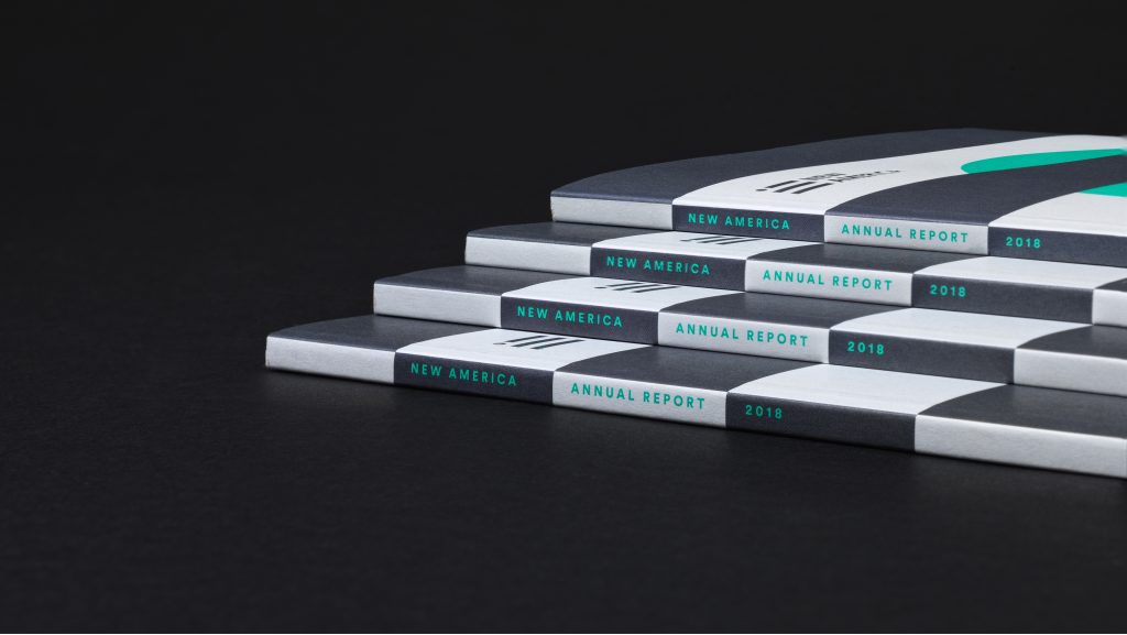 The spines of four stacked annual reports.