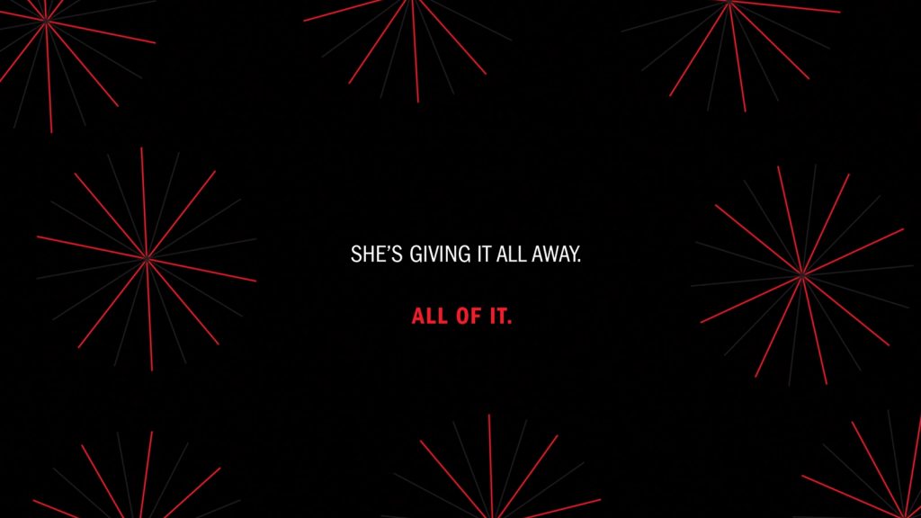 The text "She's giving it all away. All of it." in white and red type surrounded by fine red lines organised in star shapes on a black background