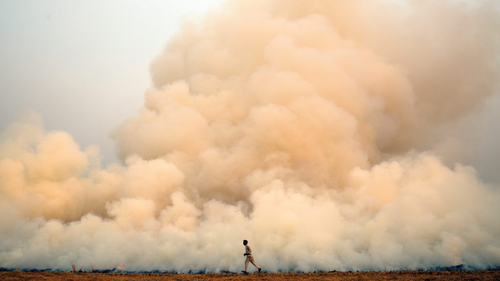 An illustrative visual showing a person against a backdrop of smoke