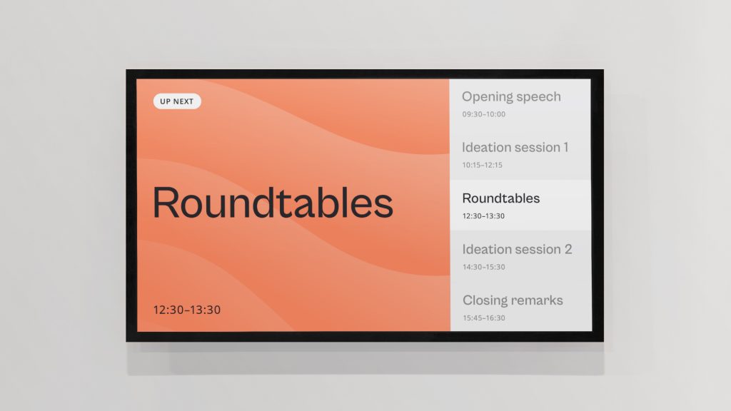 An illustration of a slide from an event showing the agenda. "Roundtables" is written on a patterned, coral background